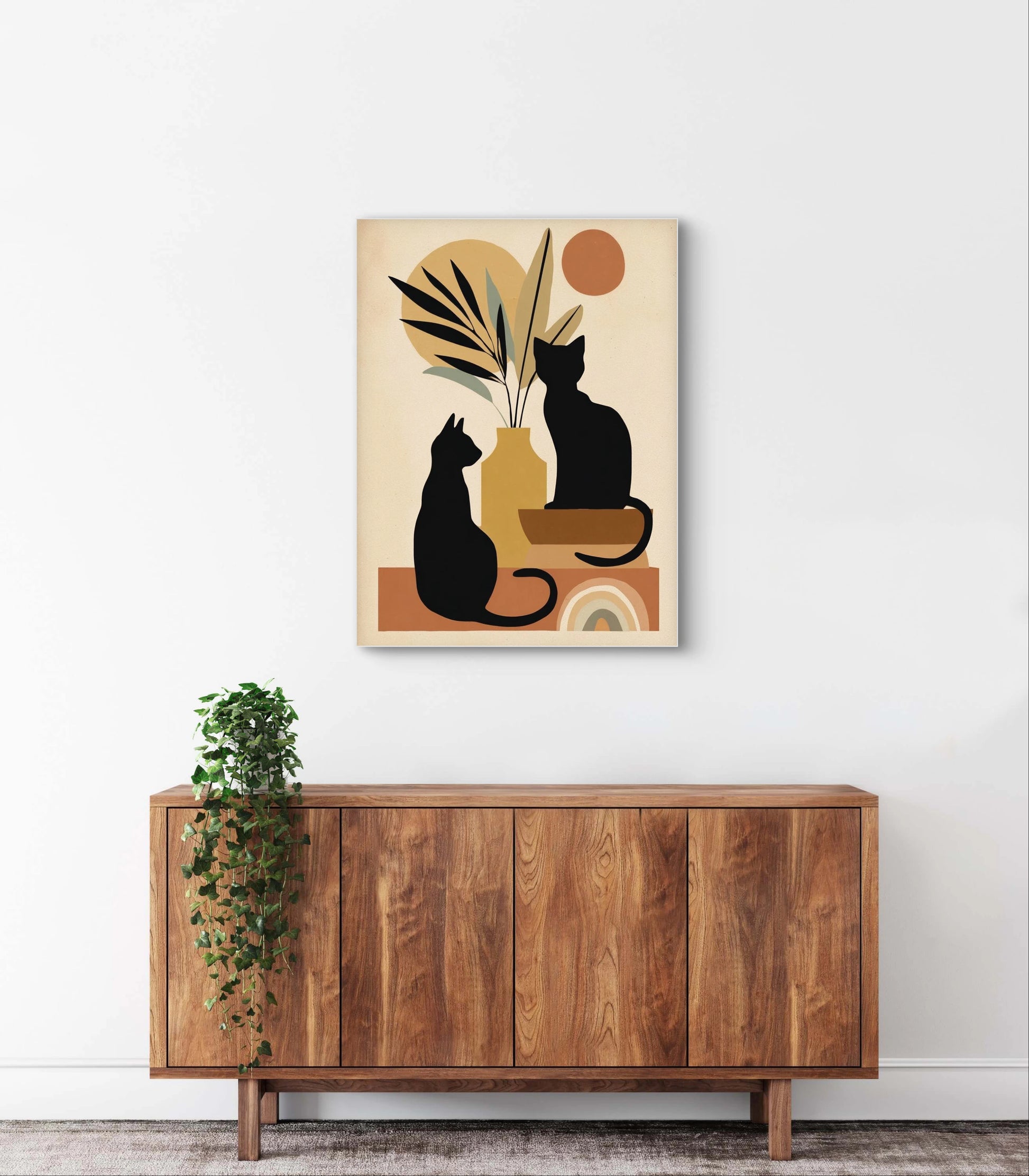 Textielkunstwerk met silhouetten van twee zwarte katten in warme aardetinten,