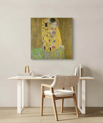 De Kus van Gustav Klimt boven een licht houten bureau met open boek en moderne styling
