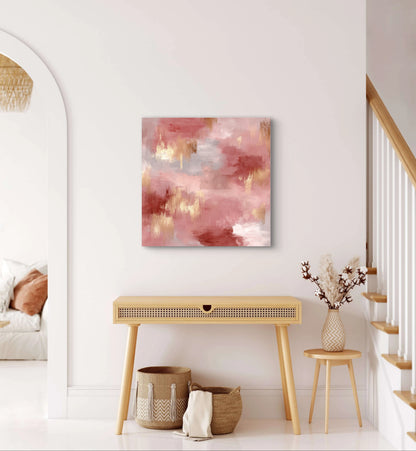 Abstract schilderij Rozennevel in roze en goudtinten boven een houten tafel in een licht interieur
