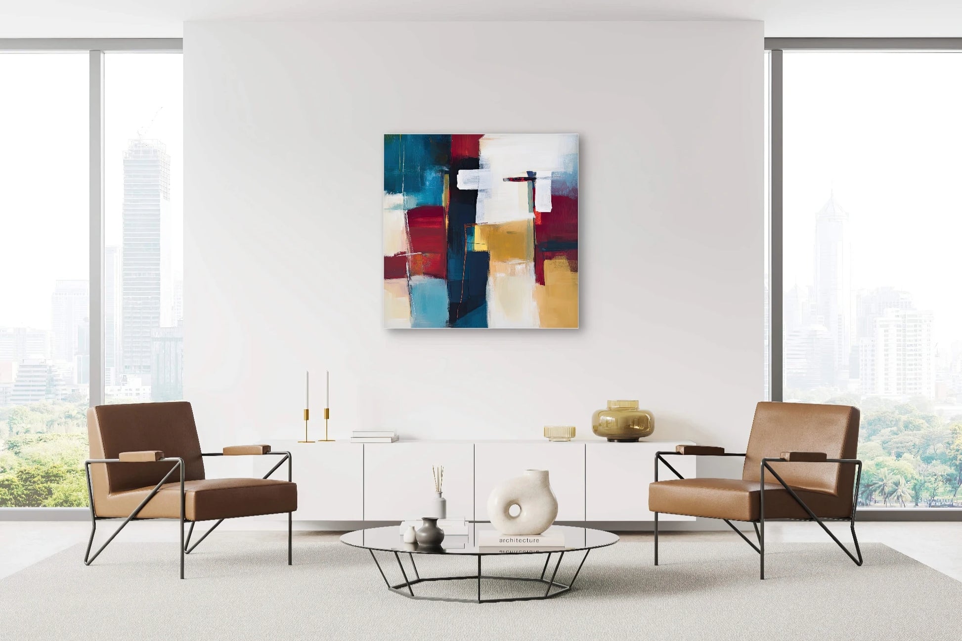 Abstract vierkant schilderij in rood, blauw, okergeel en wit boven moderne witte kast en bruine stoelen
