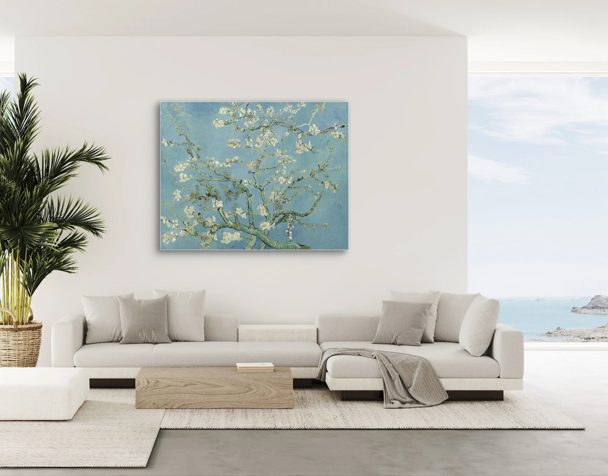 Schilderij “Amandelbloesem” van Van Gogh boven moderne witte bank met uitzicht op zee
