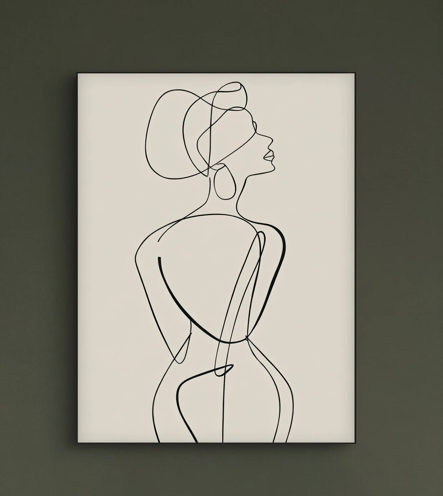 Minimalistisch lijnkunstwerk van een vrouw aan een donkergroene muur boven een lichtbeige bank in een sfeervol interieur met planten
